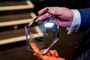Man holding Val Stokes Award